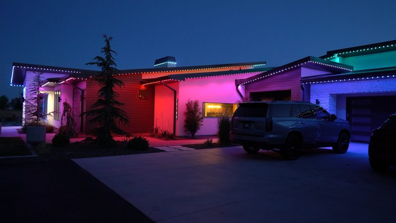 A long roofline lit in multiple colors