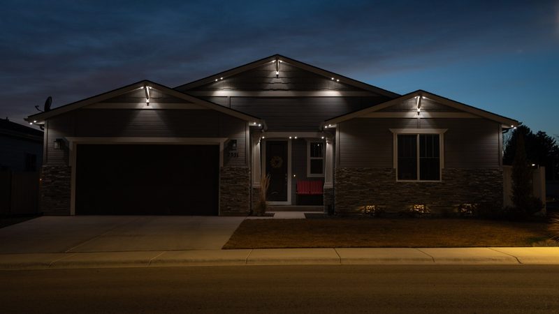 A long roofline lit in warm white at dusk