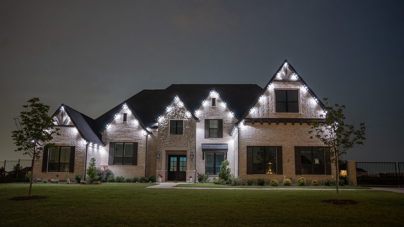 A stone gable lit in cool white